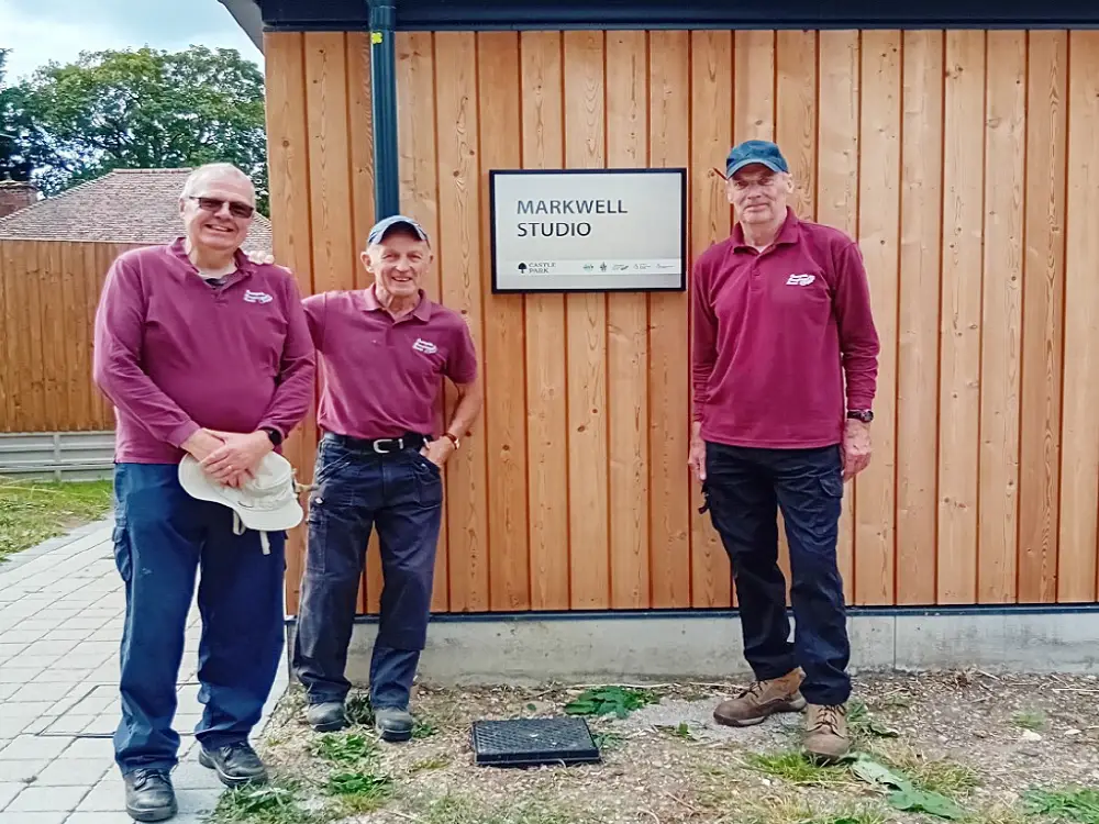 A photo of CMS Volunteers installing the sign.